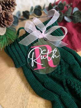 Our handmade personalized Christmas baubles are crafted from high-quality clear acrylic and customized with your chosen name and initial. Perfect for adding a personal touch to your holiday decor or gifting to someone special, these elegant ornaments come with a coordinating organza ribbon, ready for your tree!