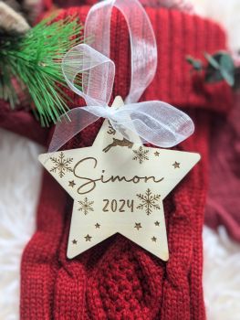 Commemorate baby&rsquo;s first Christmas with our personalized engraved wooden baubles. Available in star, round, or heart shapes, each bauble is customized with your baby's name and "2024" for a timeless holiday keepsake. Complete with a white organza ribbon, ready for gifting or adorning your tree.
