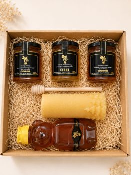 Delight your loved ones this holiday season with our enchanting Christmas gift box, thoughtfully curated for honey enthusiasts! This festive collection includes:


Honey Bear Jar: A charming honey bear filled with pure, delicious honey, perfect for adding a touch of sweetness to holiday treats and beverages.


Two Wildflower Honey Jars: Two jars of our exquisite wildflower honey, each capturing the essence of nature&rsquo;s blooms and ideal for enhancing teas, desserts, or enjoyed straight from the jar.


Heather Honey Jar: A jar of premium heather honey, renowned for its rich, complex flavor and floral aroma, making it a luxurious addition to any holiday feast.


Christmas Tree Pillar Beeswax Candle: A beautifully crafted beeswax candle in the shape of a Christmas tree, creating a warm and festive glow to illuminate the holiday spirit.


Wooden Dipper: A classic wooden honey dipper, perfect for drizzling honey onto warm biscuits or stirring into drinks.


This lovely gift box is the perfect way to share the joy of the season, making it an ideal present for family, friends, or anyone who appreciates the sweet side of Christmas.