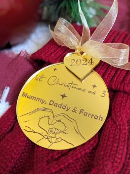 Mark your first Christmas as a family of three with our personalized 2024 Family Bauble. Featuring a beautiful engraved design of adult and baby hands with names above, this keepsake is crafted in mirror-finish acrylic with a &ldquo;2024&rdquo; charm and an organza ribbon in your choice of colours.