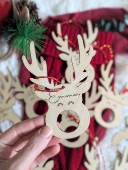 Add a touch of festive charm to your Christmas tree with our personalized Reindeer Chocolate Lindt Holder! This beautifully engraved wooden decoration makes a perfect keepsake for your own tree or a thoughtful gift for a loved one. Ideal for celebrating a baby's first Christmas, it can be customized with one name, making it a unique and personal touch.