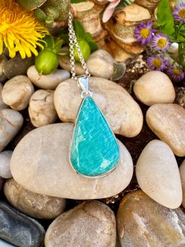 Amazonite is a calming, blue-green microcline feldspar known as the "stone of Trust and Courage" believed to foster emotional balance, clear communication, and harmony.Associated with the Heart and Throat chakras, it aids in emotional healing and speaking one's truth. It is used to reduce stress, boost confidence, and protect against electromagnetic pollution.