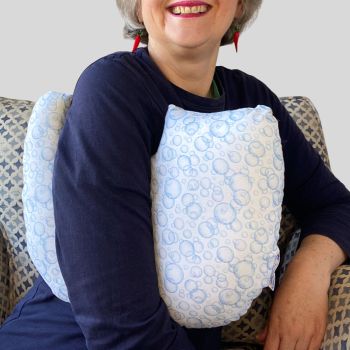* This Breast cancer surgery support pillow is ideal for use directly after surgery, or in the following weeks while healing takes place. * This support cushion is shaped to fit comfortably under the affected arm, and is filled with hollow polyester fibres to a fairly firm finish, not too hard or soft, perfect to provide adequate support and comfort. * This pillow reaches mid chest in width, so it will easily cover the surgery area, and provide support&nbsp; and padding. I am a breast cancer survivor myself so I understand what is needed after having had chest surgery, and how important comfort and support are as healing occurs. I have sought advice from the Road Safety Authority in Ireland, in relation to the suitability of my pillows to be used when driving, if positioned under a seat belt. They recommend that I advise caution to customers on the use of aids that have the potential to interfere with any safety features in the car, and potentially increasing risk of injury. I want to ensure customers that I take their safety and security sincerely when ordering products from my shop. * It measures 43cm wide X 37cm long and 10 cm in depth. This fun blue soap bubbles print fabric and is soft and breathable. All cushions come with a made with love by Rodgerson Handcraft label and are reversible.