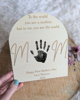 Celebrate Mom's love and devotion with this beautifully engraved wooden plaque, featuring the heartfelt message: "To the world you are a mother, but to me you are the world." With space for your child's handprint and a custom message, this sentimental keepsake makes the perfect Mother&rsquo;s Day, birthday, or just-because gift.