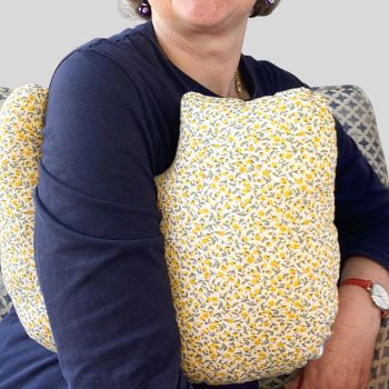 * This is my post mastectomy/lumpectomy/upper chest surgery support pillow is ideal for use directly after surgery, or in the following weeks while healing takes place. * This support cushion is shaped to fit comfortably under the affected arm, and is filled with hollow polyester fibres to a fairly firm finish, not too hard or soft, perfect to provide adequate support and comfort. * This pillow reaches mid chest in width, so it will easily cover the surgery area, and provide support&nbsp; and padding. I am a breast cancer survivor myself so I understand what is needed after having had chest surgery, and how important comfort and support are as healing occurs. I have sought advice from the Road Safety Authority in Ireland, in relation to the suitability of my pillows to be used when driving, if positioned under a seat belt. They recommend that I advise caution to customers on the use of aids that have the potential to interfere with any safety features in the car, and potentially increasing risk of injury. I want to ensure customers that I take their safety and security sincerely when ordering products from my shop. * It measures 43cm wide X 37cm long and 10 cm in depth.
This petite yellow spring flowered print fabric. This fabric is soft and breathable. All cushions come with a made with love by Rodgerson Handcraft label and are reversible.