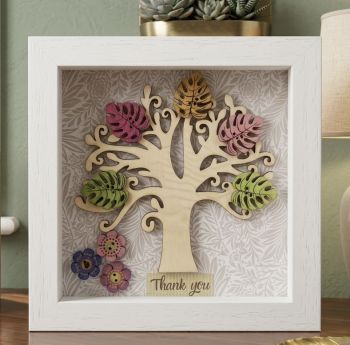Handmade wooden tree frame with colourful wooden leaves and flowers.