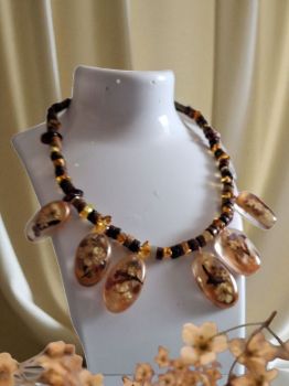 One-of-a-kind handmade necklace from the Honey Glow series. Crafted with genuine Baltic amber, Picasso Jasper beads, and floral epoxy resin pendants — a warm memory of summer captured in every detail.