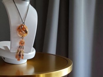 Unique long pendant with cascading resin drops and dried flowers. Warm honey tones. Bronze chain.