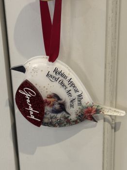 Beautifull Acrylic memorial robin with glitter red breast.
Measures 10cm, supplied with a red satin ribbon and gift box.
A name can be added to the red breast.