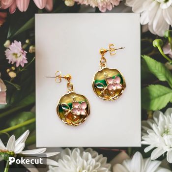 A lovely pink flower on a colourful background, similar to a sunset setting over a field of grass. Small rounded gold ball as the earring stud