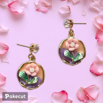 Cute dusty pink flower on a colourful enamel charm. Orange and purple colours in the background. With a gemed stud for the earring