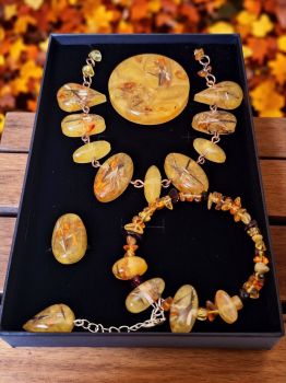 A unique handmade jewelry set with real marigold seeds and amber, beautifully preserved in resin.