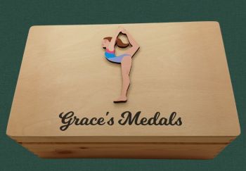 Personalised Gymnastics Medal box, with option to put club crests on box.&nbsp; Choose hair colour, skin tone and kit colour. Box is finished with a non toxic wax.
The dimensions of the box are 29cm x 18cm x 13cm a very generous size to store all your well earned medals.
The ideal gift for any gymnastic fanatics with a medal haul and nowhere to store them. Leave them speechless with this personalised keepsake box, something they will have to cherish their medals . This personalised gymnastics medal keepsake box is the perfect gift for a birthday, mothers day, fathers day, communion, confirmation or Christmas present. A truly unique gift.