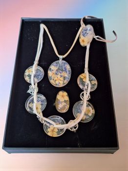 Botanical jewelry set with real pressed flowers in resin. Includes ring, bracelet, necklace & pendant. Handmade & ready to gift.