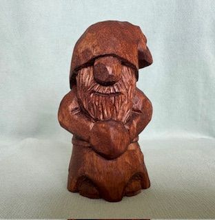 A kindly gnome carved from mahogony wood and oiled. Approximately 11x6cm. Unique item.&nbsp;