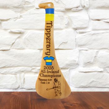 🏆 Tipperary 2025 All-Ireland Champions Display Hurley
Celebrate Tipperary&rsquo;s big win with this special keepsake hurley. Made from strong pine wood and finished with smooth, high-quality varnish, it&rsquo;s built to last and look great anywhere.
&middot;&nbsp;&nbsp;&nbsp;&nbsp;&nbsp;&nbsp;&nbsp;&nbsp; Engraved with the 2025 All-Ireland final score: Tipperary 3-27 &ndash; Cork 1-18
&middot;&nbsp;&nbsp;&nbsp;&nbsp;&nbsp;&nbsp;&nbsp;&nbsp; Features Tipperary colours and jersey design
&middot;&nbsp;&nbsp;&nbsp;&nbsp;&nbsp;&nbsp;&nbsp;&nbsp; Includes a built-in stand on the back for easy display
&middot;&nbsp;&nbsp;&nbsp;&nbsp;&nbsp;&nbsp;&nbsp;&nbsp; Size: 32cm high &times; 12cm wide
Perfect for fans, collectors, or as a gift to mark a proud moment in hurling history.
🌲 Please note: Because each hurley is made from natural pine, you may see small knots or grain patterns in the wood. These are part of its charm and make every piece unique.
Perfect for fans, collectors, or as a gift to mark a proud moment in hurling history.&nbsp;&nbsp;&nbsp;&nbsp;&nbsp;&nbsp;&nbsp;&nbsp;&nbsp;&nbsp;&nbsp;&nbsp;&nbsp;&nbsp;&nbsp;&nbsp; A beautiful way to remember a historic win&mdash;and a great gift for any true Tipp supporter.