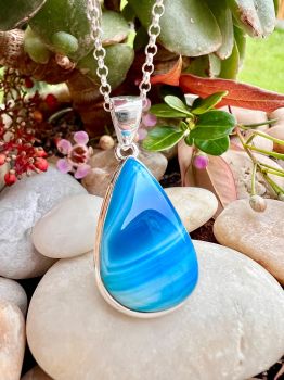 This beautiful Blue Hues Botswana Agate Sterling Silver Necklace is a unique handmade piece that will make a statement with any outfit. The gorgeous blue hues of the Botswana Agate stone are bezel set in sterling silver, perfect for adding a touch of class to any look, this necklace is a one-of-a-kind piece and a great addition to any jewelry collection.