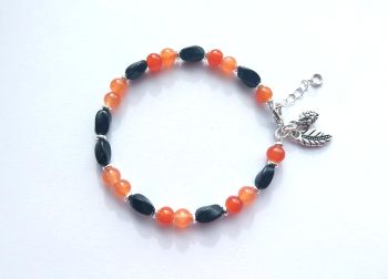 Gorgeous handmade bracelet with black acrylic beads, orange glass beads and with silver plated beads, and extension chain.&nbsp; It also has cute antique silver autumnal charms. A lightweight bespoke bracelet, perfect for Autumn/Halloween!&nbsp; It arrives in a pretty organza bag, and has free shipping.