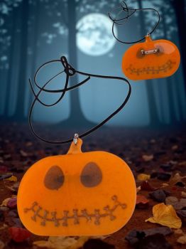 Handmade resin pumpkin pendant-brooch, bright orange with stitched smile. Wear it as a necklace or brooch for the perfect Halloween look.