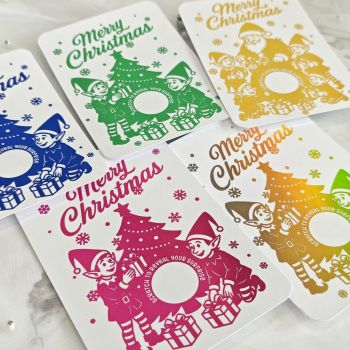A Magical Christmas Surprise
Bring joy and wonder to the holidays with our&nbsp;Gold Foil Christmas Scratch-Off Card, featuring playful elves, a Christmas tree, and a hidden surprise message. Perfect for gifting loved ones, this interactive card adds sparkle and excitement to your festive celebrations.
🎄 Key Features

Elegant&nbsp;gold foil design&nbsp;with festive elf and tree artwork
Includes a&nbsp;gold scratch-off sticker&nbsp;to hide your surprise message
Printed on premium&nbsp;300gsm cardstock&nbsp;for a high-quality finish
Comes with an&nbsp;eco-friendly kraft envelope, ready to gift
Ideal for&nbsp;family, friends, children, or holiday gift reveals
Handmade in Ireland&nbsp;with care and attention to detail

✨ Why It&rsquo;s Special
This isn&rsquo;t just a Christmas card &ndash; it&rsquo;s an experience. Write your message under the scratch-off area and let them reveal it in a magical way. From surprise trips to heartfelt notes, this card creates a moment they&rsquo;ll never forget.
📏 Product Details

Size: A6 (10.5 &times; 14.8 cm / 4.1 &times; 5.8 in)
Material: 300gsm smooth cardstock
Envelope: Kraft envelope included
Scratch Sticker: 5cm round gold sticker
