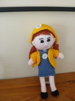 Crochet doll in yellow hat and jacket