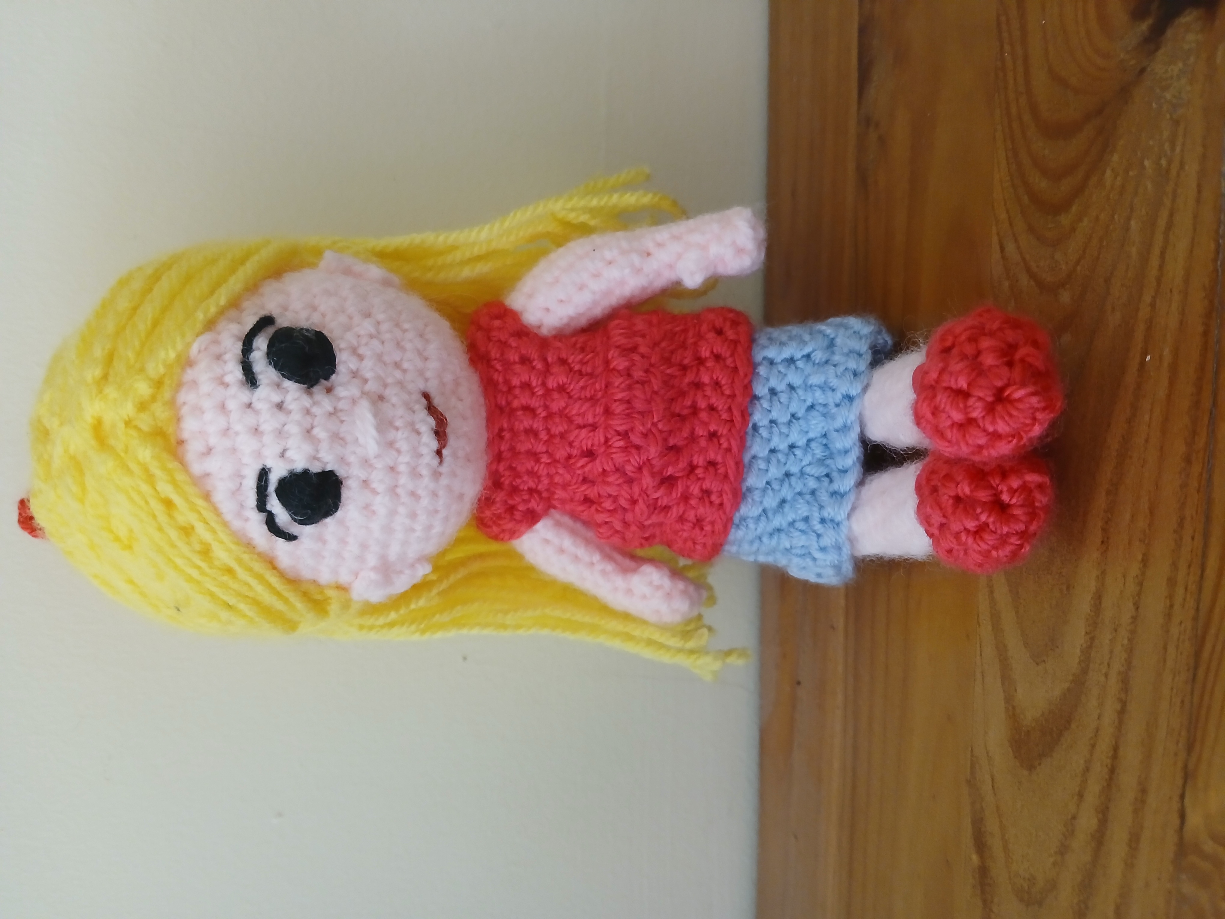 Blonde haired doll in pink tee and blue skirt