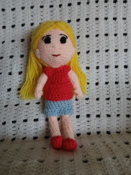 Blonde haired doll in pink tee and blue skirt