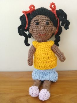 Crochet doll in curly pigtails