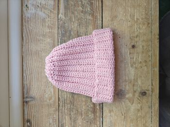 Keep your newborn cozy and adorable with this handmade crochet baby hat in soft pink.