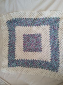 Mixed white and blue colour granny square crochet baby blanket.