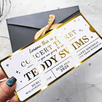 Personalised Foil Ticket Features &amp; Handmade Details
Celebrate their love for live music with a personalised Teddy Swims concert foil ticket. Handmade in County Cork, Ireland by Printarelle, these keepsakes are crafted to make your concert reveal a moment they&rsquo;ll never forget. Perfect for birthdays, anniversaries, or just because.
How to Order


Enter the name, event details, date, and personal message.


You can choose your preferred foil color and envelope option.


Please double-check all information before placing your order to make sure it's correct.



Important Notes


All details must be correct at the time of ordering. We'd like to carefully review everything before submitting to avoid delays or printing errors.


This is a keepsake gift and does not grant entry to any real event.


Each ticket is securely shipped in a rigid, hard-backed envelope to ensure it arrives in perfect condition.


If you have any special requests or require fully custom designs, please don't hesitate to contact us.


&nbsp;
Give a truly one-of-a-kind gift with a personalized foil ticket &ndash; a stylish and thoughtful way to celebrate any occasion!