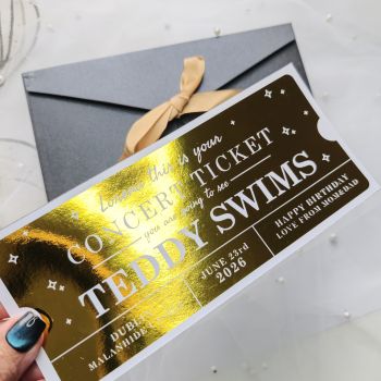 Personalised Foil Ticket Features &amp; Handmade Details
Celebrate their love for live music with a personalised Teddy Swims concert foil ticket. Handmade in County Cork, Ireland by Printarelle, these keepsakes are crafted to make your concert reveal a moment they&rsquo;ll never forget. Perfect for birthdays, anniversaries, or just because.
How to Order


Enter the name, event details, date, and personal message.


You can choose your preferred foil color and envelope option.


Please double-check all information before placing your order to make sure it's correct.



Important Notes


All details must be correct at the time of ordering. We'd like to carefully review everything before submitting to avoid delays or printing errors.


This is a keepsake gift and does not grant entry to any real event.


Each ticket is securely shipped in a rigid, hard-backed envelope to ensure it arrives in perfect condition.


If you have any special requests or require fully custom designs, please don't hesitate to contact us.


&nbsp;
Give a truly one-of-a-kind gift with a personalized foil ticket &ndash; a stylish and thoughtful way to celebrate any occasion!