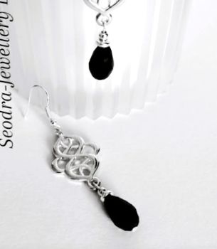 Handmade earrings, created with silver plated celtic knots, silver plated beads and crystal glass drops in black. They are suspended from silver plated, nickel free ear wires, suitable for sensitive ears. Lightweight, comfortable to wear and very versatile.. Elevate your style with these gorgeous bespoke pieces.. They arrive in a pretty organza bag, and have free shipping.
