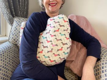 My breast cancer surgery support pillows are ideal for use directly after surgery, or in the following weeks while healing takes place. This support pillow is shaped to fit comfortably under the affected arm, and is filled with high quality polyester filling to a fairly firm finish, perfect to provide adequate support and comfort. This pillow reaches mid chest in width, so it will easily cover the surgery area, and provide support&nbsp; and padding.
It measures 43cm wide X 37cm long and 10 cm in depth. This dachshunds in jumpers fabric is soft and breathable. All pillows come with a handmade with love by Rodgerson Handcraft label and are reversible.