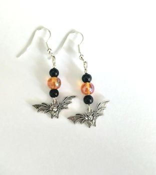 Two pairs of Halloween earrings.... one pair created with cute antique silver skeletons on silver plated, nickel free ear wires, and the other pair created with antique silver bats, with black acrylic beads and iridescent glass beads in orange, these are also on silver plated, nickel free earwires.&nbsp; Lightweight and easy to wear and perfect for Halloween festivities!&nbsp; They arrive in a pretty organza bag, and have free shipping