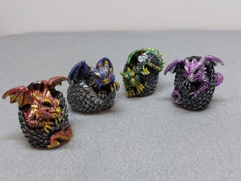 Hatching Dragons Figurines - 4 Colors: Red, Blue, Green &amp; Purple - 5cm - Dragonling emerging from the scaled eggshell💎 Four intricately crafted dragon hatchlings emerging from their scaled, protective grey scaled eggshells. Each dragon possesses a unique and mesmerizing shimmer, with colors ranging from a vibrant blue and fiery red to regal purple and lush green.💎 Ideal for those in search of fantastic creatures, our dragon-themed giftware collection invites you to explore the extraordinary.