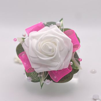 A pretty keepsake debs flower corsage made with an artificial white rose and attached to a white pearl bracelet.&nbsp;
