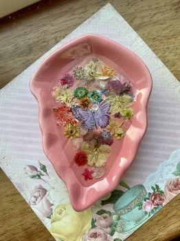 Ring dish with dried flowers and resin.
