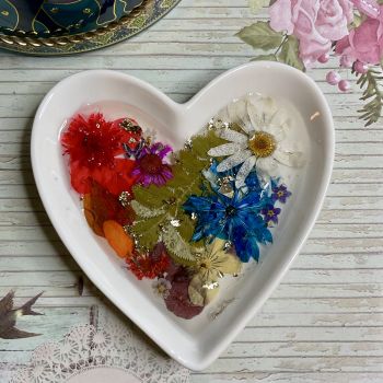 Ring dish with dried flowers and resin.