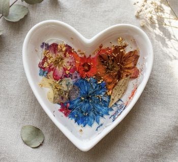 Ring dish with dried flowers and resin.