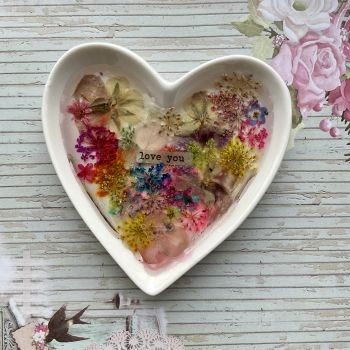 Ring dish with dried flowers and resin.
