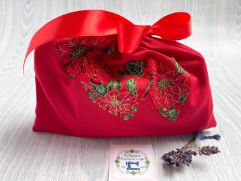 This gift bag is made using Red 100% cotton Christmas fabric featuring red poinsettia hearts appliqued. This small gift bag is finished to a high standard and is drawstring tied with matching red ribbon. It is reusable gift wrapping and will make a great tradition for wrapping Christmas presents.