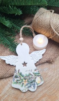 Handmade clay Christmas angel decoupaged in festive theme.