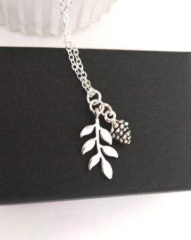 Gorgeous antique silver leaf pendant, with antique silver pine cone charm. Suspended from a silver plated chain..The drop on the pendant is approx. 2.54cm/1in. The chain length is approx. 45.7cm/18ins, plus extension chain. approx. 5.08cm/2ins. Enhance your style with this beautiful bespoke piece… It arrives in a pretty organza bag, and has free shipping
