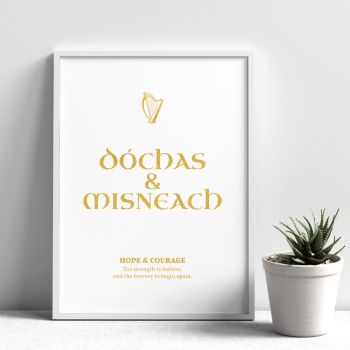 Celebrate Irish language and meaning with our &ldquo;D&oacute;chas &amp; Misneach&rdquo; (Hope &amp; Courage) gold foil print. Each piece is hand-foiled in County Cork, Ireland, for a luminous mirror finish that catches the light beautifully. Choose from A4, A5, or A6. Unframed and shipped flat&mdash;ready to gift or frame.
About This Gaelic Wall Art

&ldquo;D&oacute;chas &amp; Misneach&rdquo; brings quiet strength to any space&mdash;bedroom, hallway, office, or gallery wall. Minimal, elegant typography and an Irish motif make it a timeless keepsake that blends with modern and traditional d&eacute;cor.