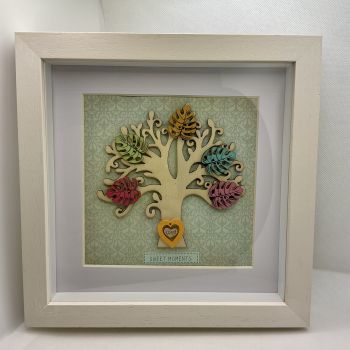 Wooden tree frame with colourful wooden leaves.