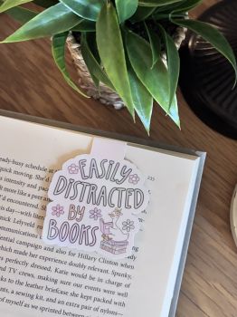 A fun and bookish handmade magnetic bookmark featuring the phrase "Easily Distracted by Books" with a cute illustrated duck reading on a stack of books. A perfect gift for book lovers, teachers or anyone who happily gets lost in a good story.&nbsp;