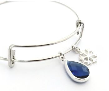 A gorgeous polished stainless steel adjustable bracelet, with a silver plated snowflake charm, and a silver framed, faceted glass bead in deep tblue. Lightweight and comfortable to wear&hellip;.Perfect for Christmas/Gifting/Stocking filler...It arrives in a pretty organza bag, and has free shipping!