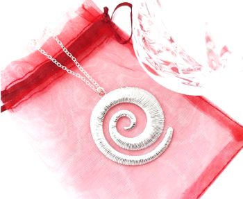 A gorgeous polished stainless steel spiral pendant ( approx. 4.8cm/1.88ins ), suspended from a silver plated chain (approx. 50.8cm/20ins in length, with extension chain (approx.5cm/2ins). A beautiful, versatile pendant, lightweight and easy to wear&hellip;. Enhance your look with this gorgeous piece! It arrives in a pretty organza bag, and has free shipping!