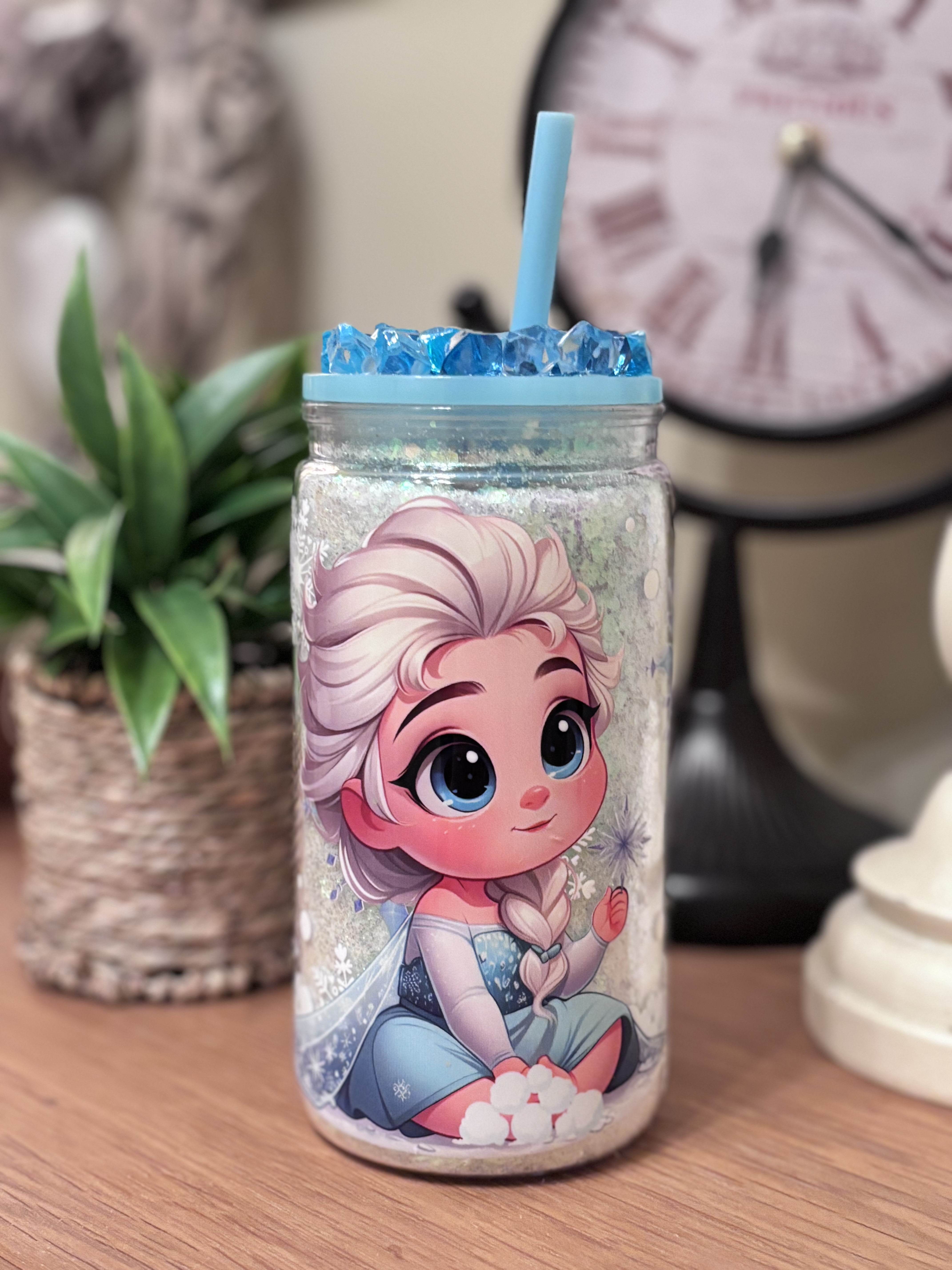 A magical 16oz acrylic glitter tumbler featuring a cute ice princess and a handmade crystal-style topper. Perfect for kids, winter gifts, and sparkle lovers.